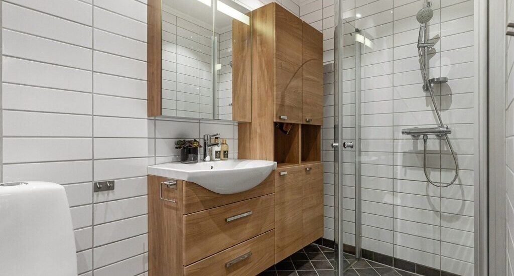 24 inch glass shower door in compact modern bathroom