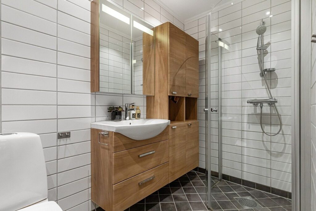 24 inch glass shower door in compact modern bathroom