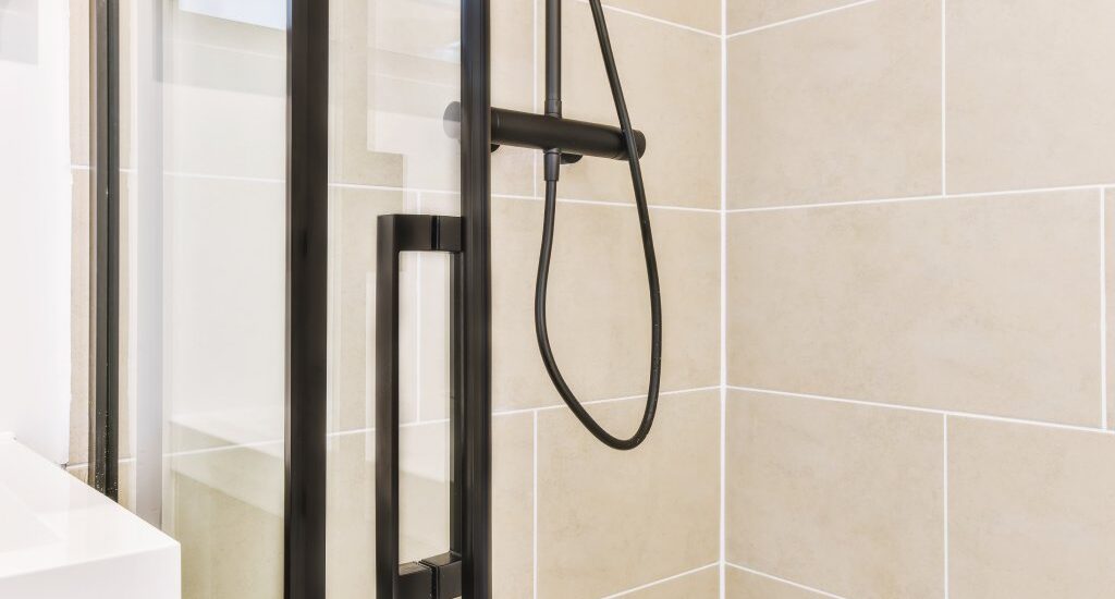 Zero threshold neo angle shower with matte black hardware