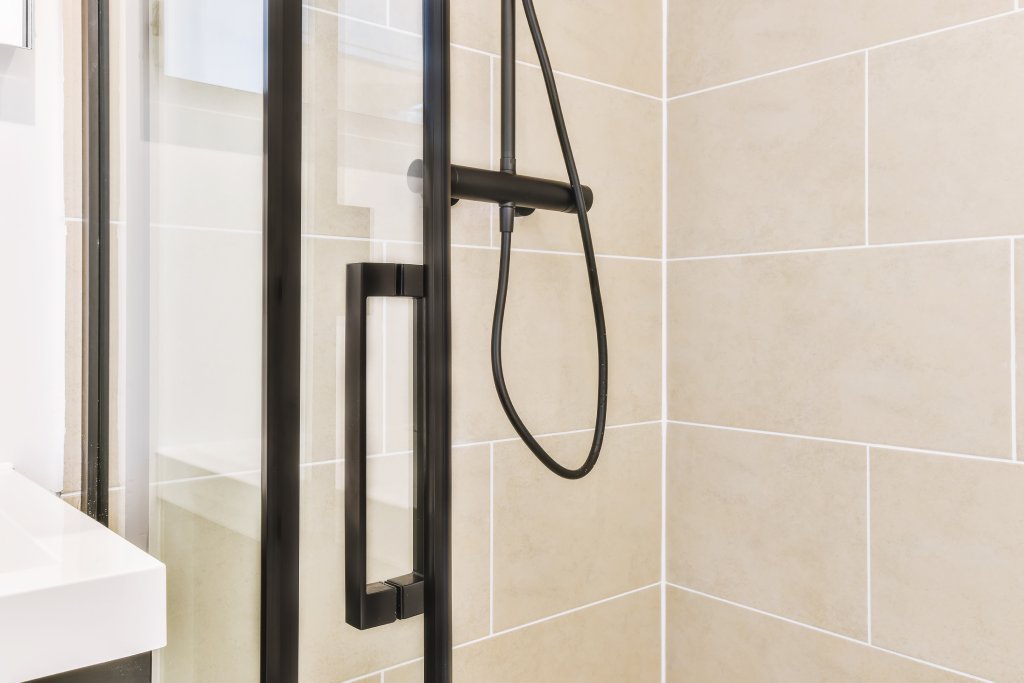 Zero threshold neo angle shower with matte black hardware
